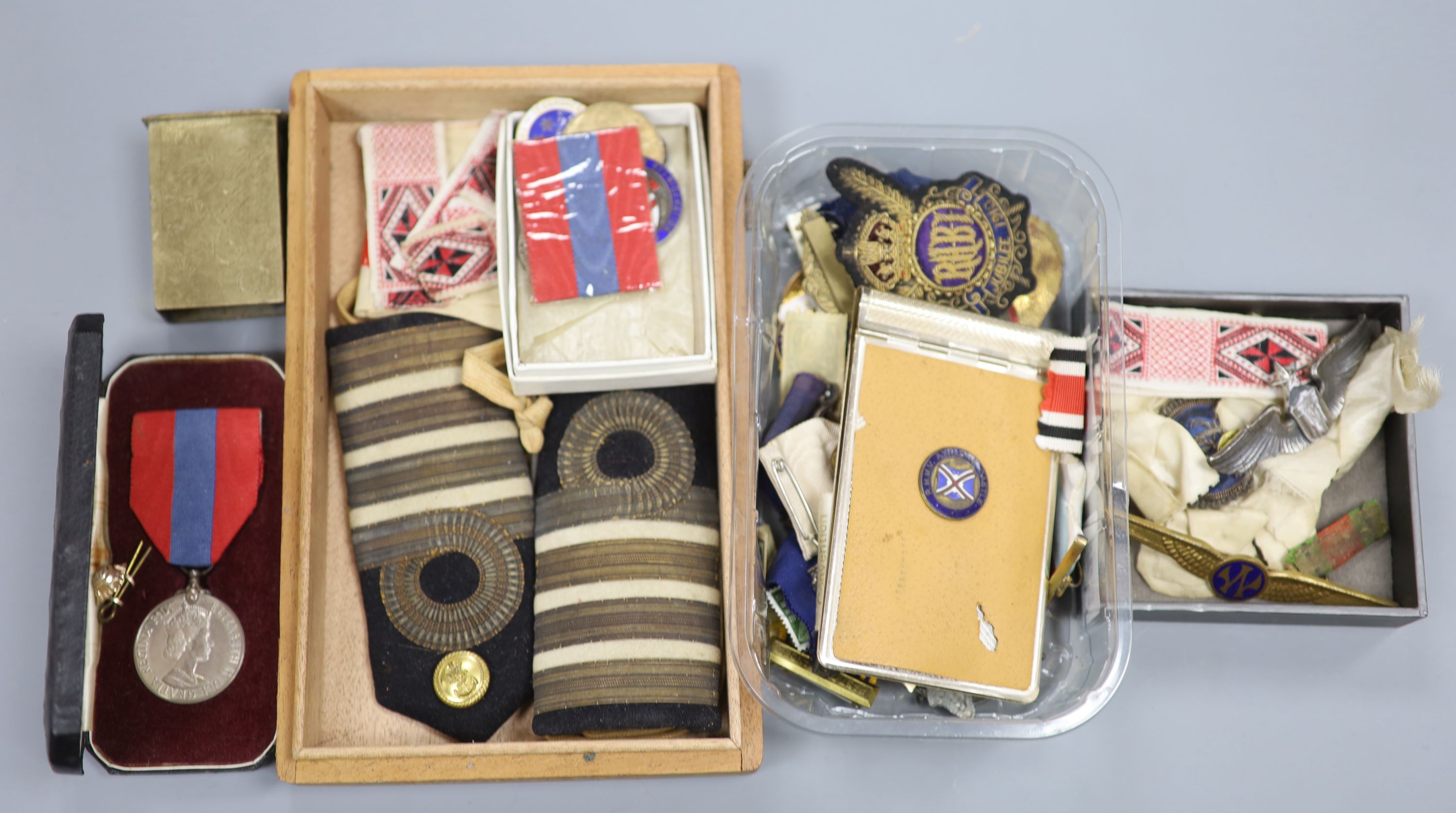 A collection of military medals, badges, coins etc.